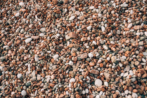 Pebbles on the beach. Texture of the sea shore. The Adriatic Sea in Montenegro.