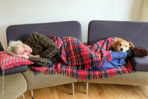 man and dog nap on couch