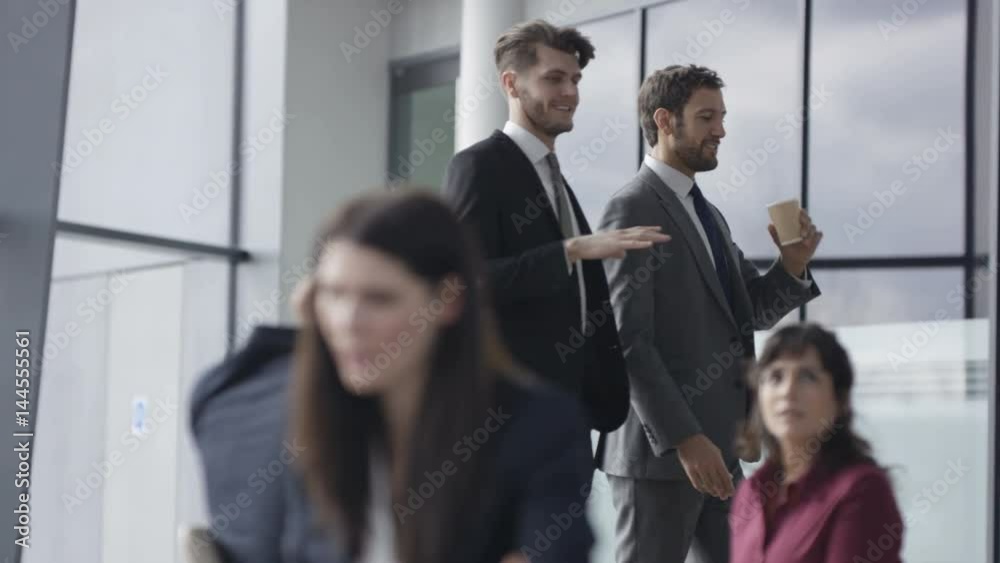 Corporate business group in discussion in busy meeting area of modern office Corporate business group in discussion in busy meeting area of modern office