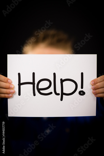 Child holding Help sign