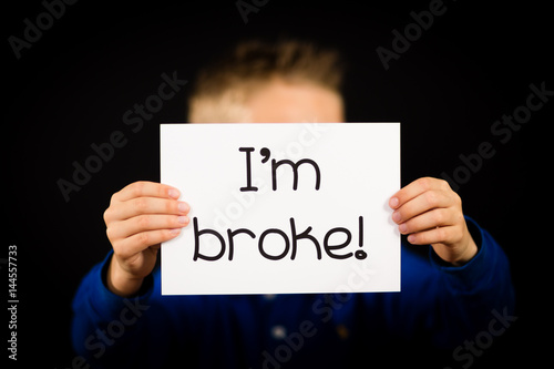 Person holding I am broke sign