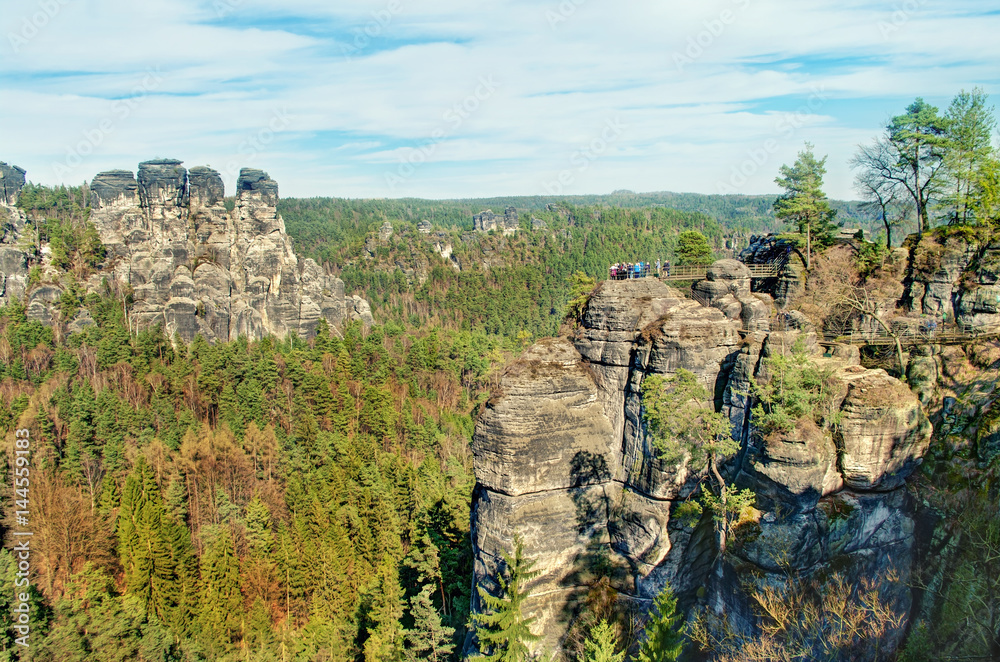 view of vertical rock formations surrounded by trees
