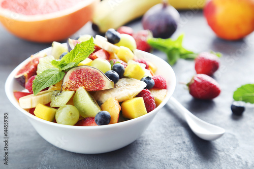 Fresh fruit salad on a grey wooden table