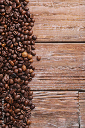 Roasted coffee beans on a brown wooden table
