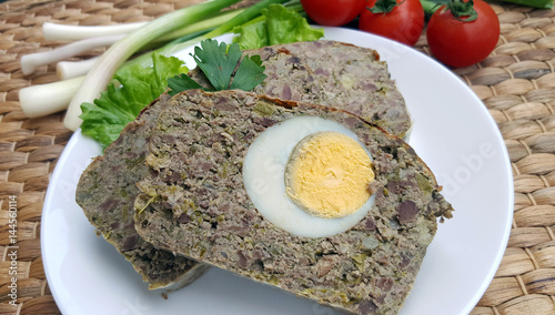 Baked meatloaf with boiled eggs photo