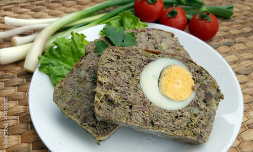 Baked meatloaf with boiled eggs photo