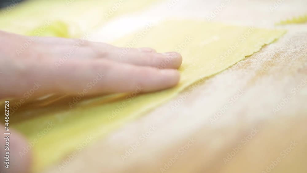 Professional cutting pasta from a sheet of raw dough In a restaurant cafe close-up, slow mo Professional cutting pasta from a sheet of raw dough In a restaurant cafe close-up, slow mo