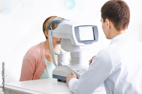 Ophthalmologist measuring i...