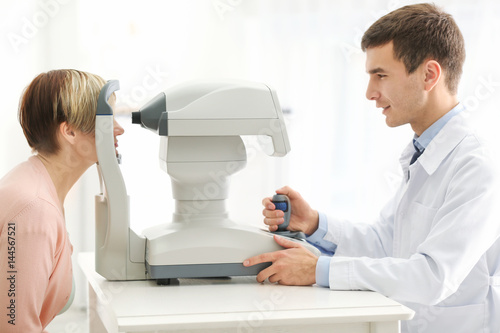 Ophthalmologist measuring i...