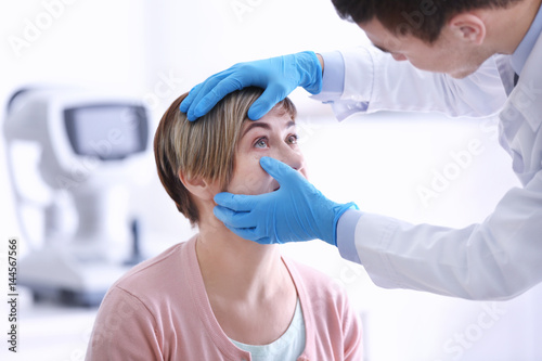 Ophthalmologist examining e...