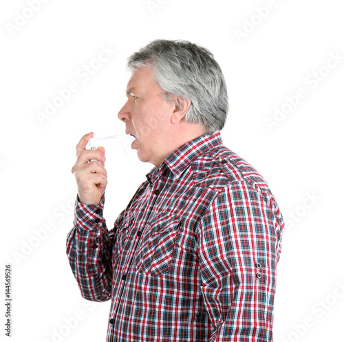 Sick senior man using throa...