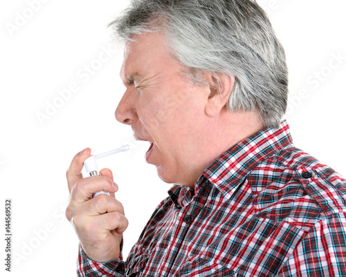 Sick senior man using throa...