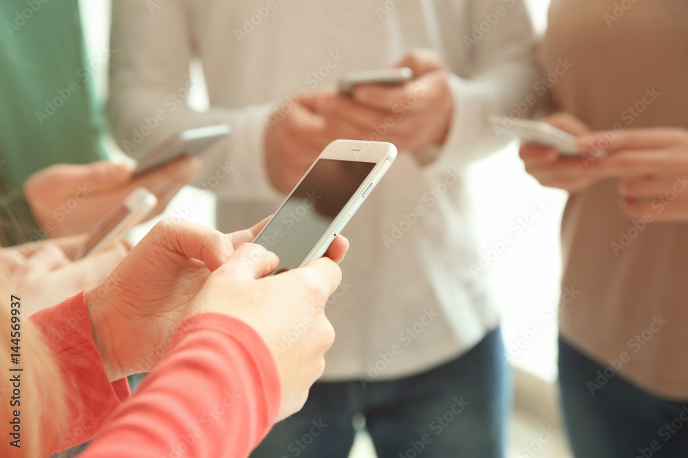 People standing together and using smartphones, closeup People standing together and using smartphones, closeup