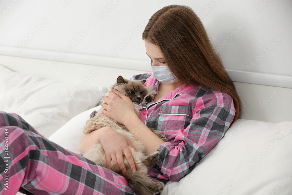 Animal allergy concept. Beautiful woman with cat in bed Animal allergy concept. Beautiful woman with cat in bed
