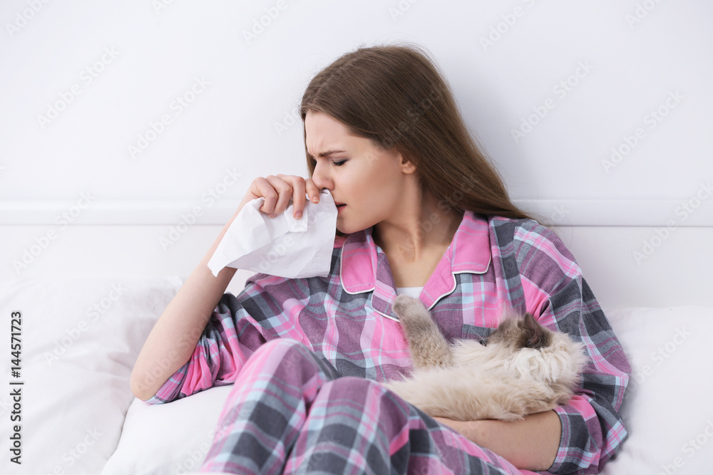 Animal allergy concept. Beautiful woman with cat in bed Animal allergy concept. Beautiful woman with cat in bed