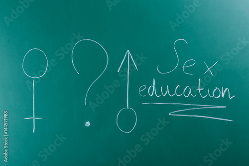 Male and female symbols with text SEX EDUCATION written on chalkboard