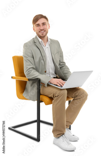 Handsome young man with lap...
