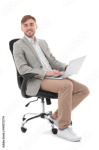 Handsome young man with lap...