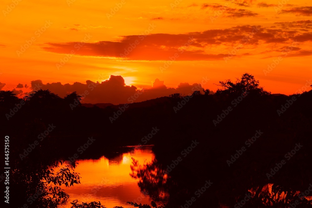 sunset beautiful colorful landscape and silhouette tree water reflexion in sky twilight time