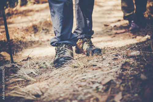 Close up of adventure man feet walk on a mountain path. © Johnstocker