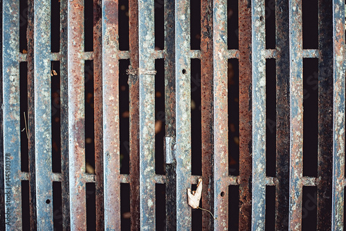 close up of rusty iron grate on the road. photo