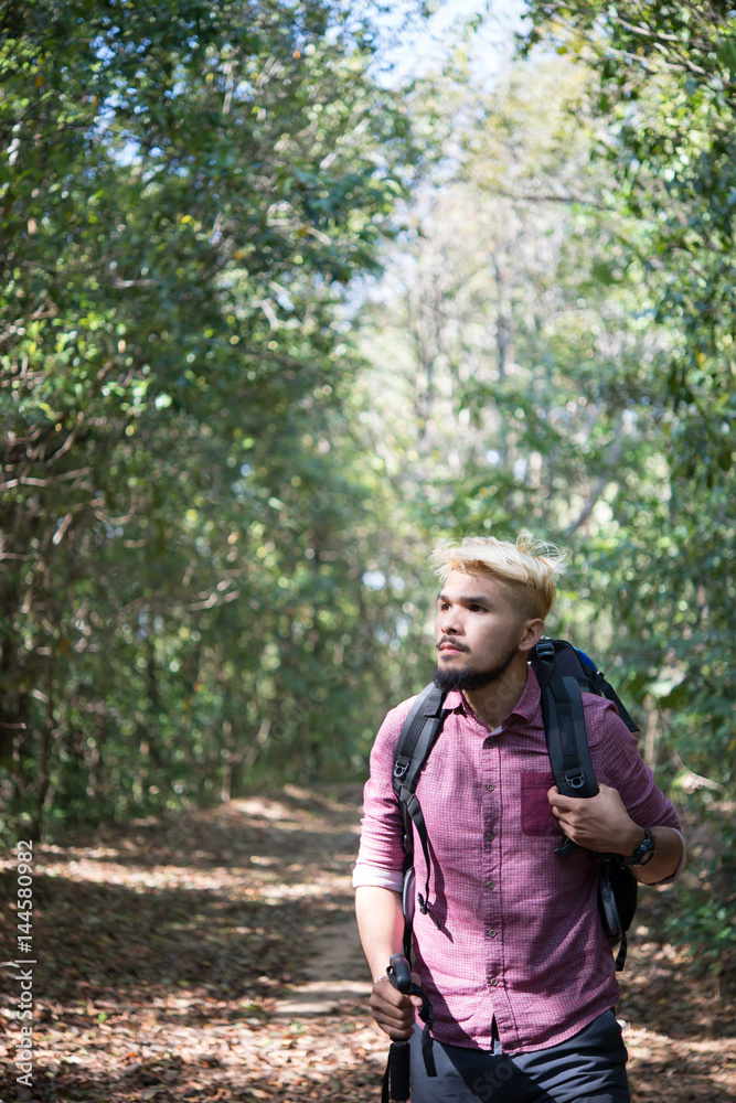 Adventure young man hiking in the mountains with a backpack. Adventure young man hiking in the mountains with a backpack.