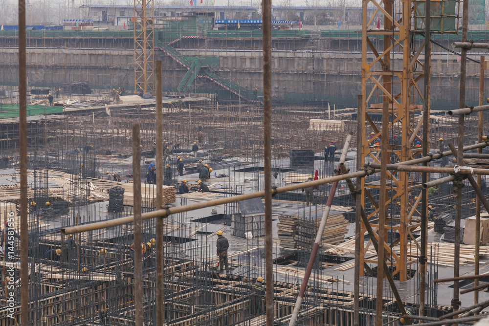 18 Dec,2014 Beijing. Work activity on a construction site in City with cranes and workers,building train station