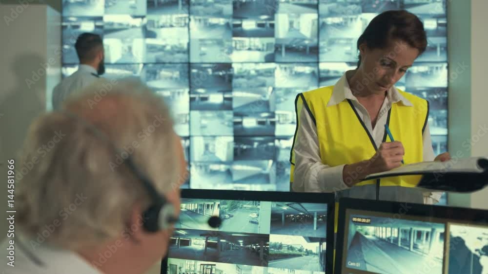 Security staff watching the screens & having a discussion in observation control room. Security staff watching the screens & having a discussion in observation control room.