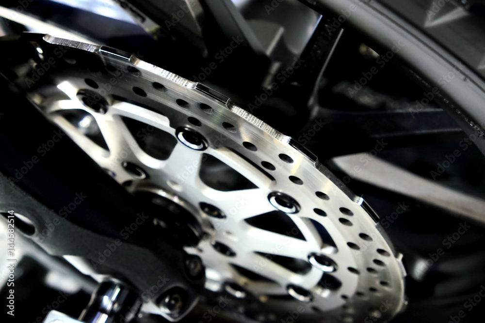 Fototapeta premium The front wheel of a motorcycle. Close up brakes and spokes