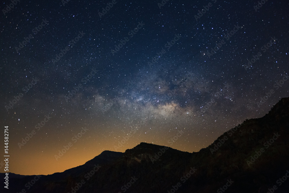 Milky way galaxy with stars over moutain, Long exposure photograph, with grain.
