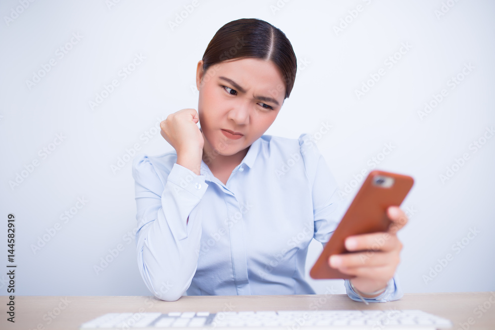 Angry woman use the smartphone in office Angry woman use the smartphone in office