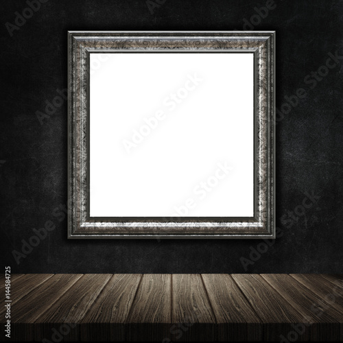 Fototapeta 3D grunge picture frame with a wooden table against a grunge metal background