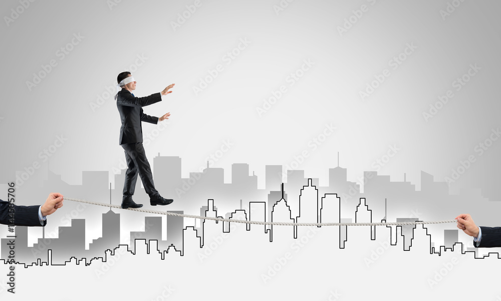 Business concept of risk support and assistance with man balancing on rope Business concept of risk support and assistance with man balancing on rope