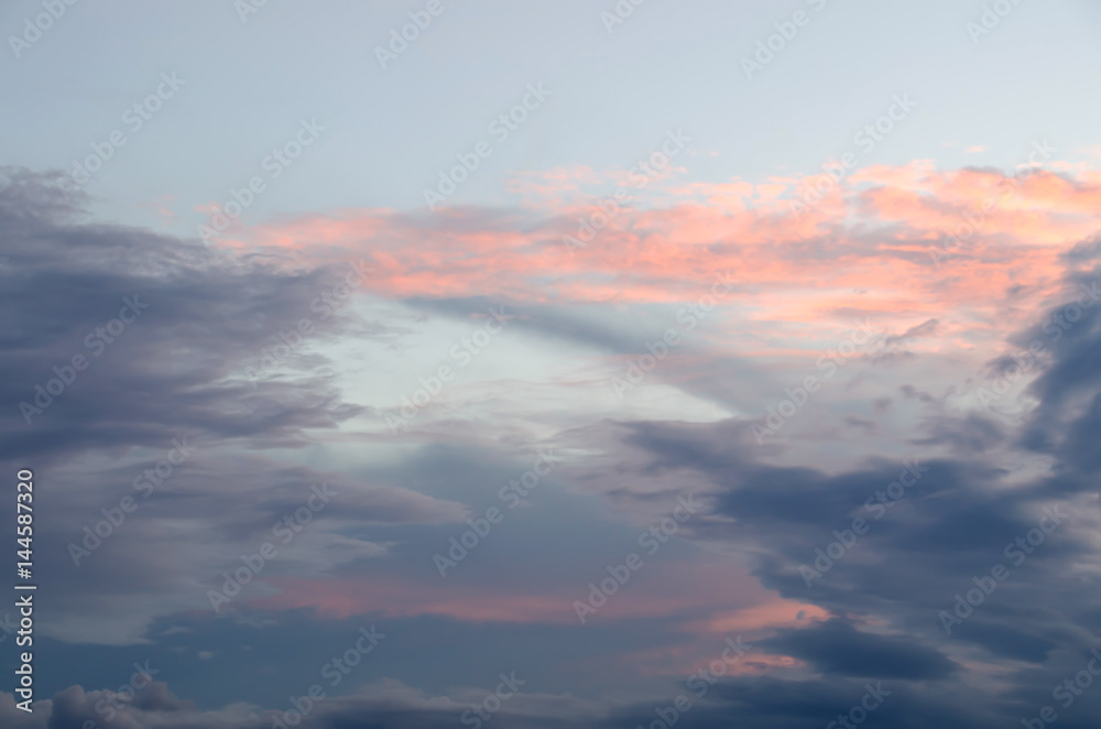 Sunset sky with golden and dark clouds. Sky cloud. 