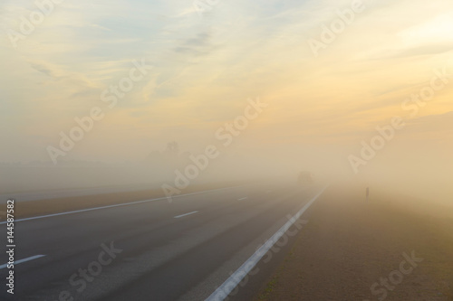 Frreway and a car in fog © BY-_-BY