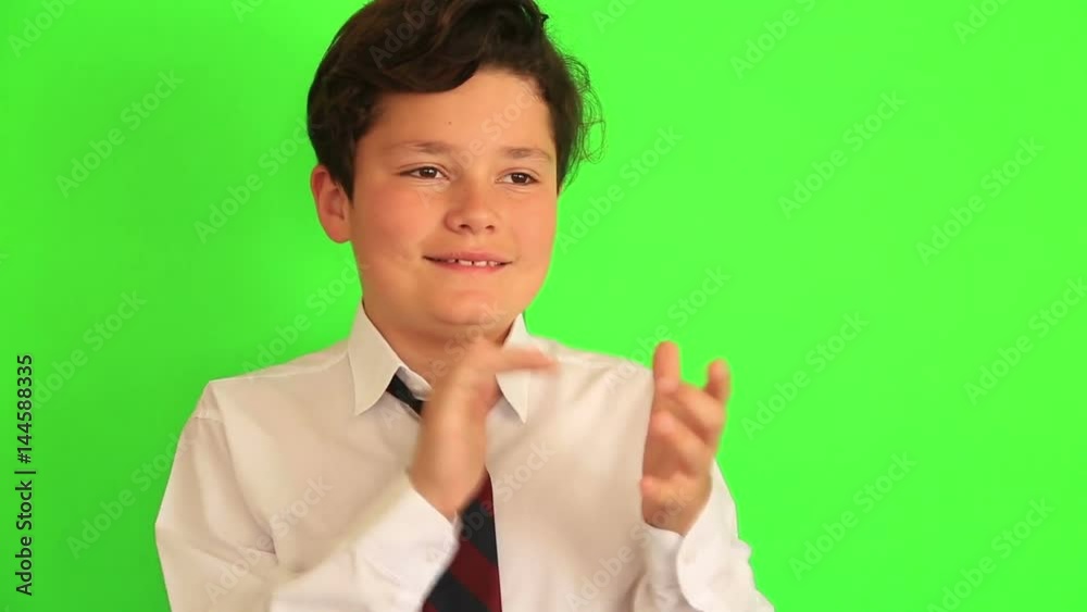 Young boy clapping on chroma key green screen background Young boy clapping on chroma key green screen background