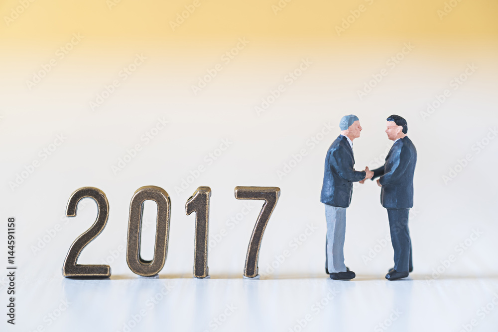 business miniature people make handshaking agreement in new year 2017 business miniature people make handshaking agreement in new year 2017