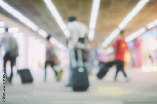 blur background of terminal departure with passengers in an airport