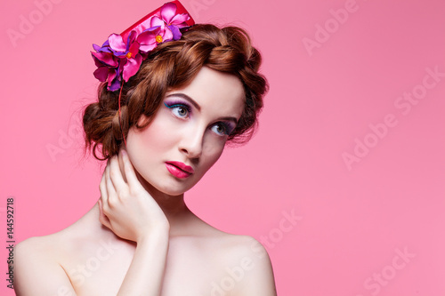Beautiful girl with bright make-up and pink hat