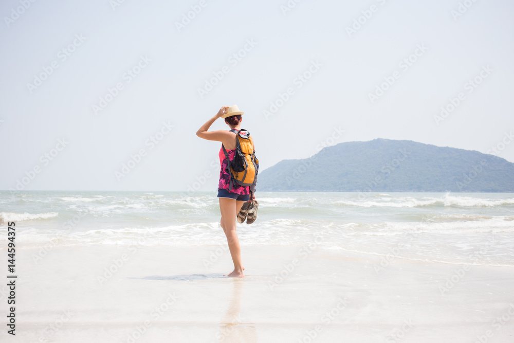 Brunette with sandals in hands