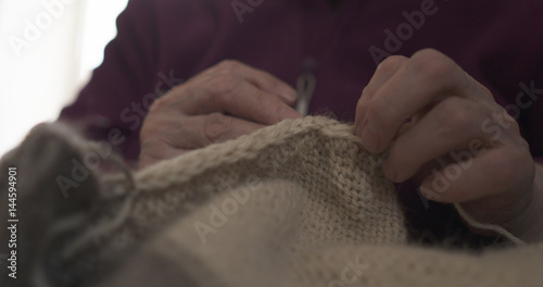 grandmother hands knitting sweater closeup  4k photo