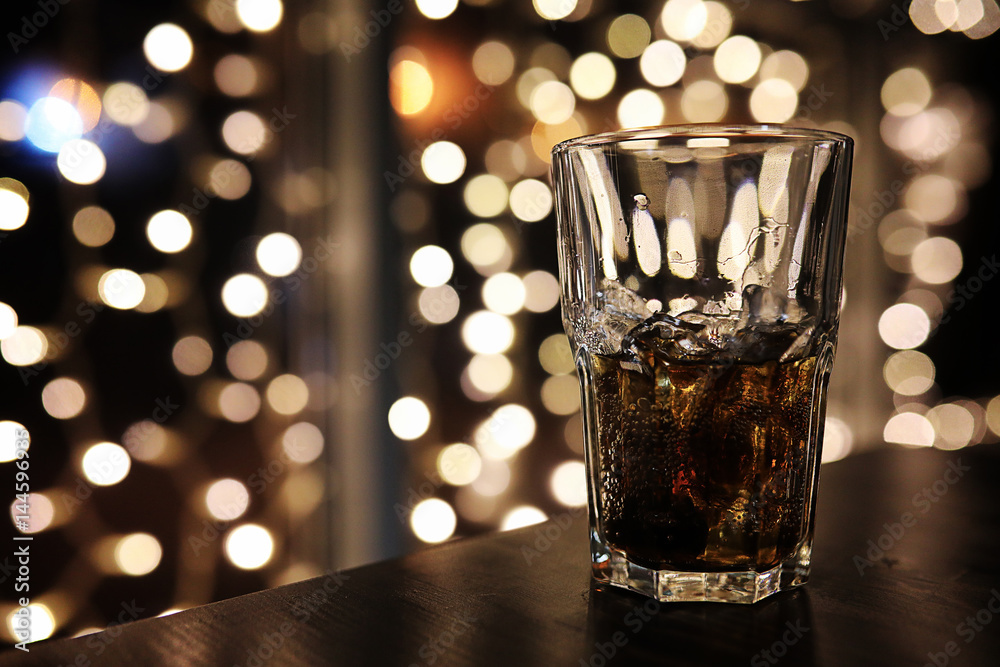 glass of alcohol with ice on blured background with circle bokeh glass of alcohol with ice on blured background with circle bokeh