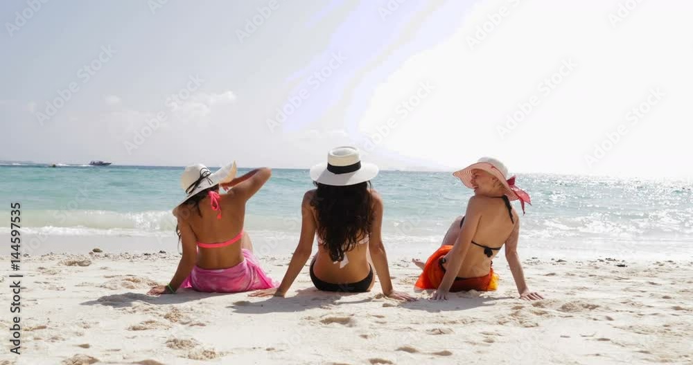 Back Rear View Of Three Girls On Beach In Bikini, Enjoy Sun Tan Talking ...