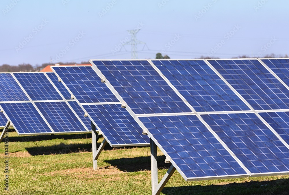 Sun and solar panels in a field. Solar energy power plant. Industrial and ecological concept for nature and eco / green technology. Sun and solar panels in a field. Solar energy power plant. Industrial and ecological concept for nature and eco / green technology.