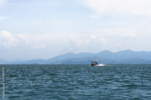Longtail boat on the sea with island background in Satun, Thailand