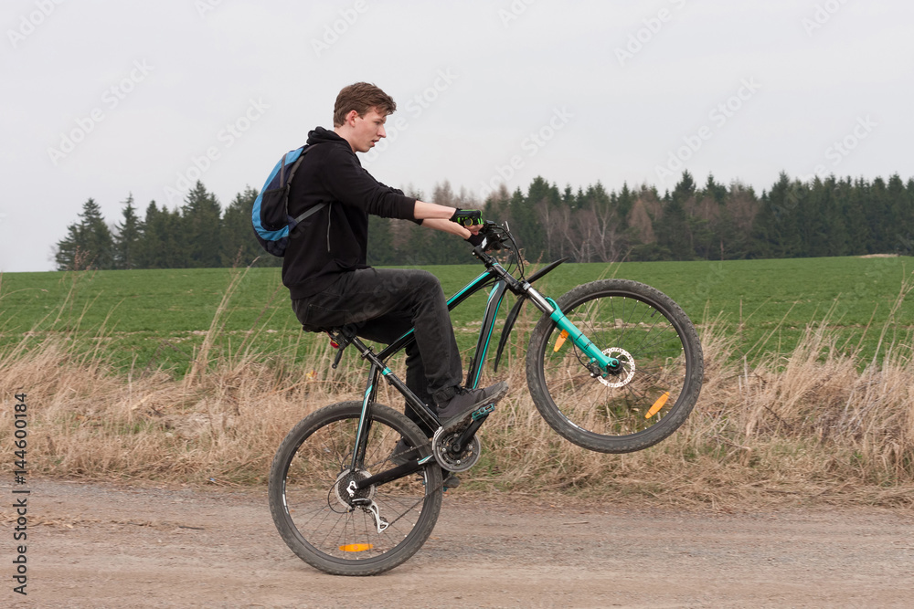 Fototapeta premium Young man on mountain bike jumping on path.