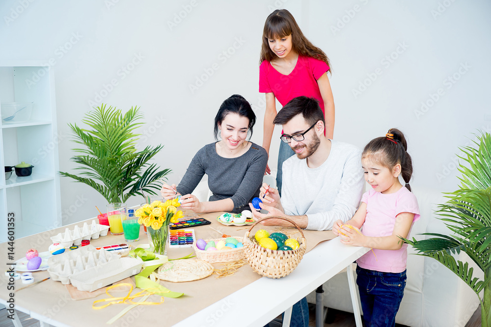 Family painting eggs