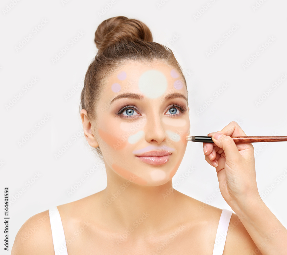 Сoverage foundation and a concealer . Contouring.Make up woman face Сoverage foundation and a concealer . Contouring.Make up woman face