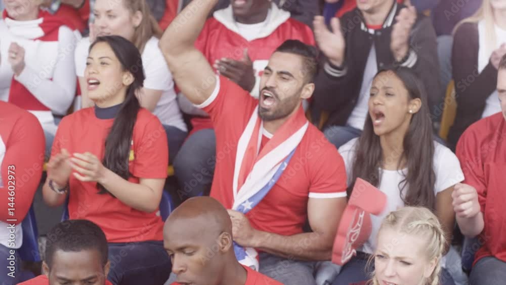 Crowd of spectators watching sports game in stadium react to good & bad play Crowd of spectators watching sports game in stadium react to good & bad play