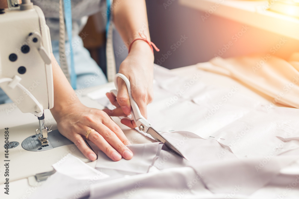 pattern, scissors, tape measure, and a sewing machine. Workplace